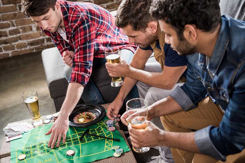 Group Of Men Gambling Together