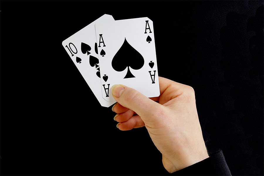 hand holding best classic blackjack combination ten and ace of s