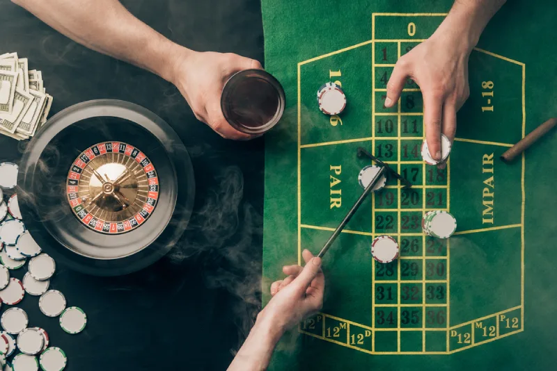People Placing Bets While Playing Roulette On Roulette Table